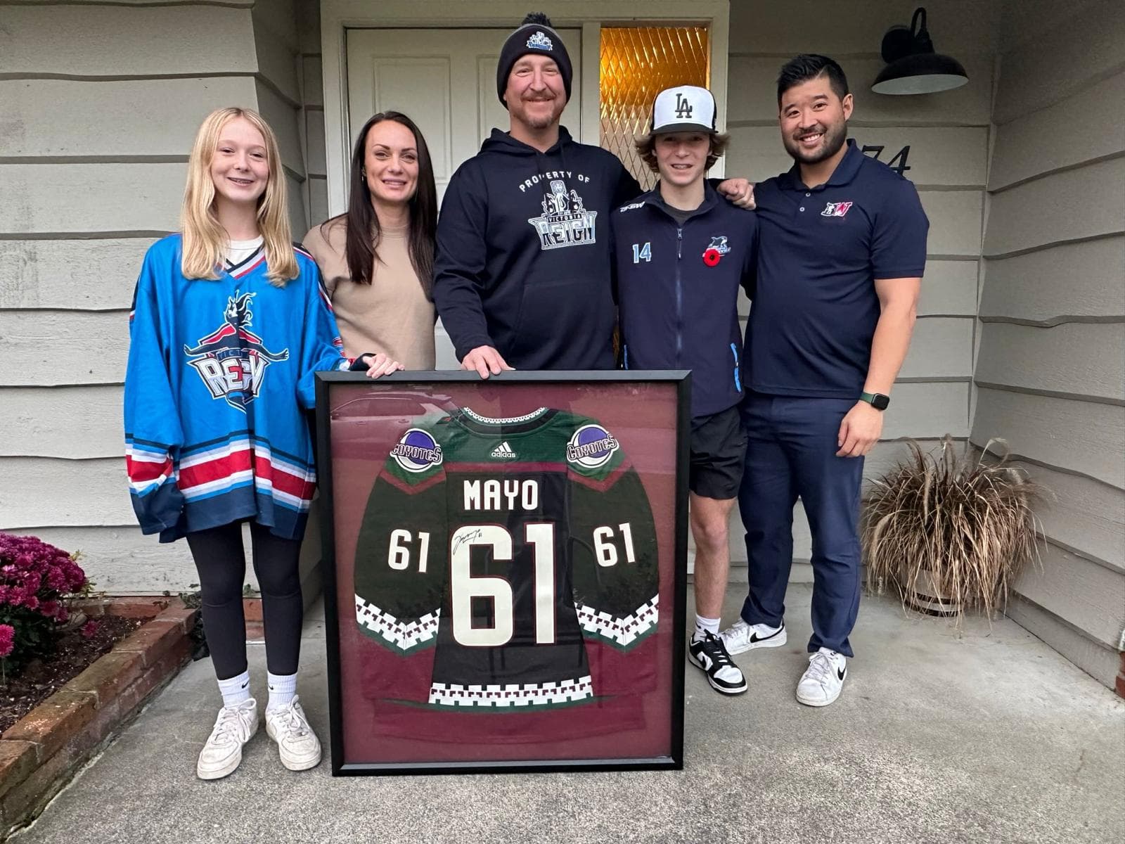 A Biggest Assist Award recipient with their signed, framed jersey