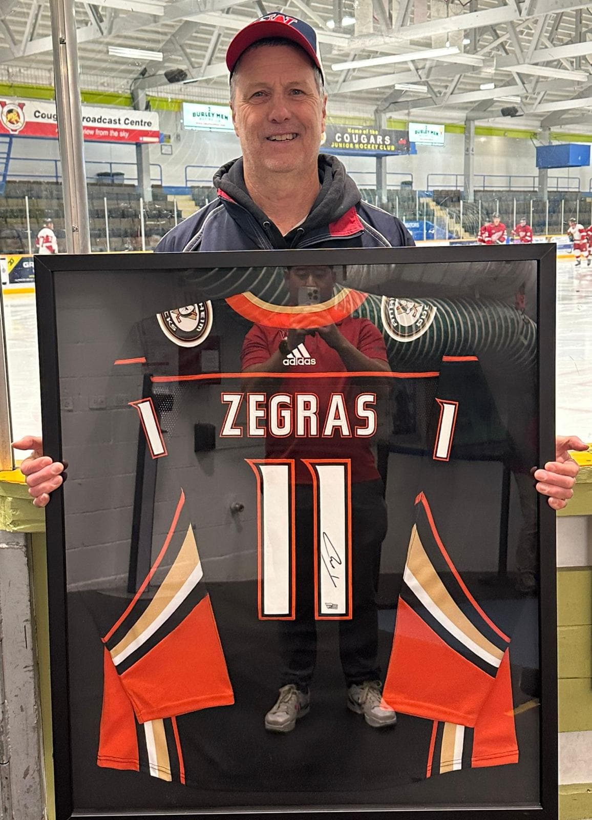 A Biggest Assist Award recipient with their signed, framed jersey